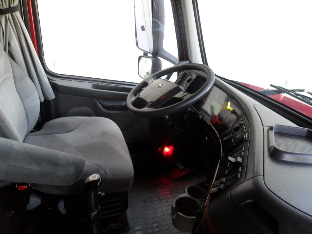 interior of truck with steering wheel and console